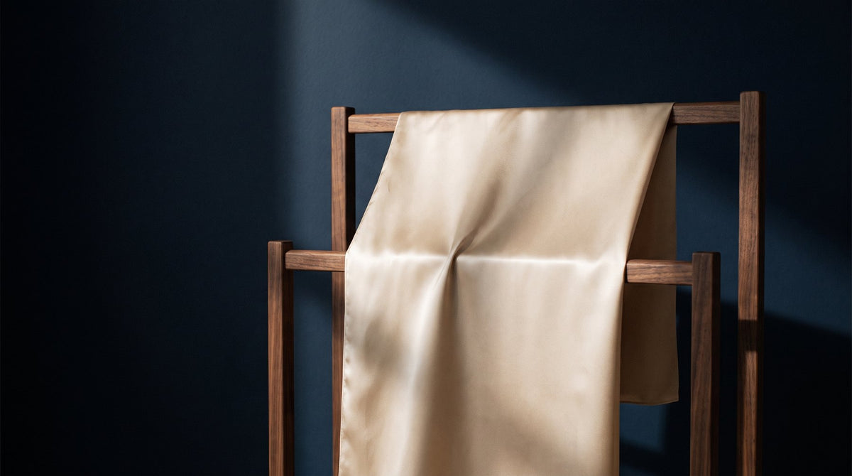 A mulberry silk pillowcase drying flat on a white towel in a shaded room