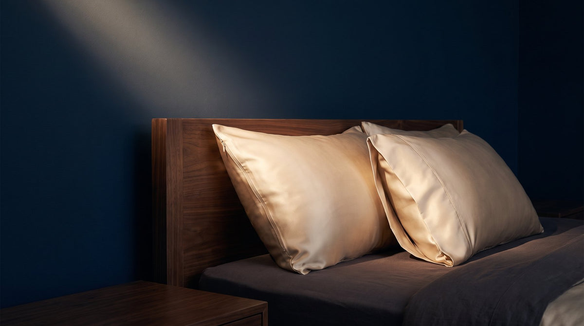 Two silk pillowcases side by side, one with a zipper edge and one with an envelope flap