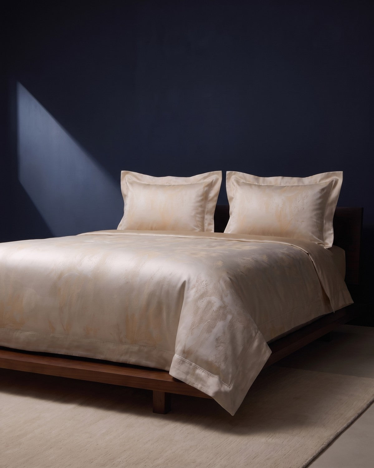 KINT silk bedding set on a low walnut bed