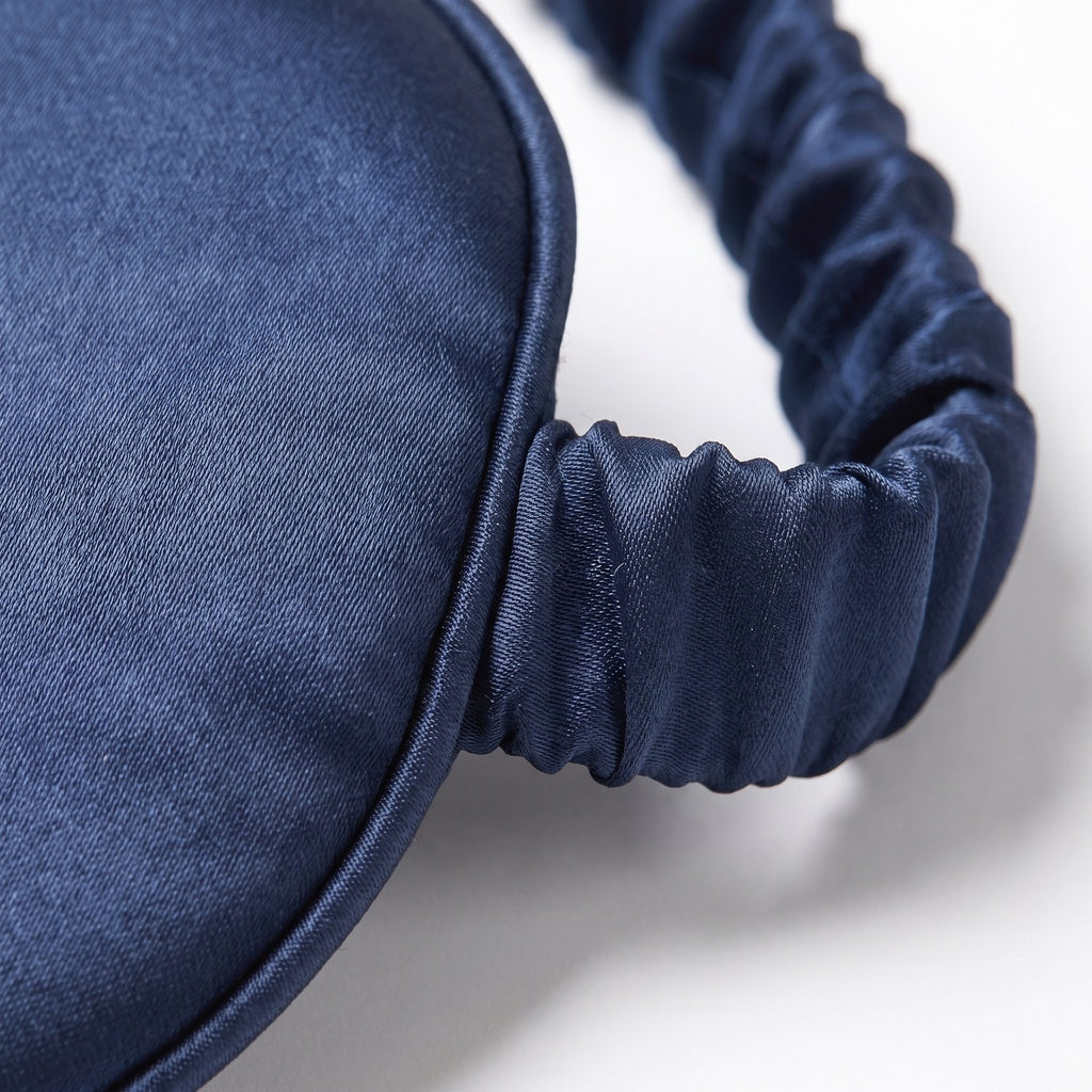 Close-up of the silk weave, piped edge and gathered silk band of the KINT classic sleep mask