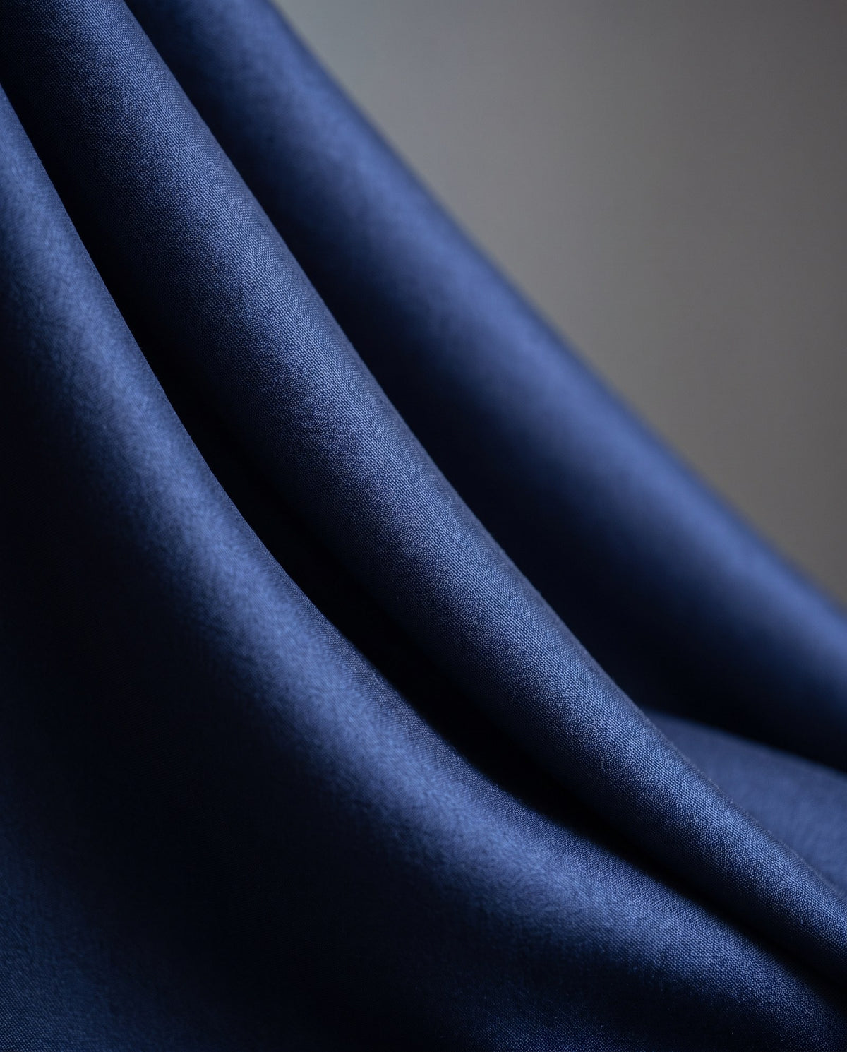 Close-up of draped navy KINT mulberry silk