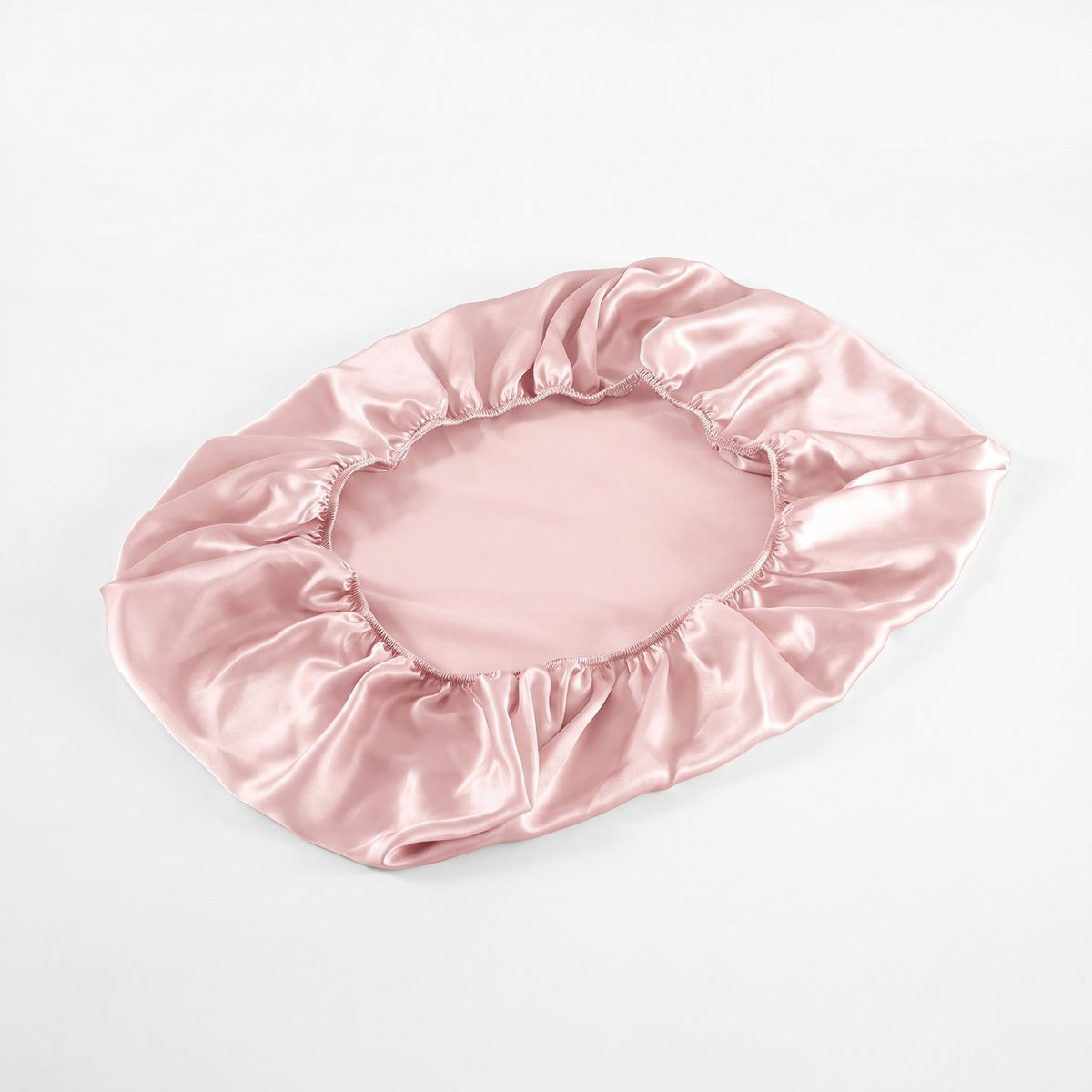 The fitted KINT silk pillow cover on its own, showing the elastic edge all around