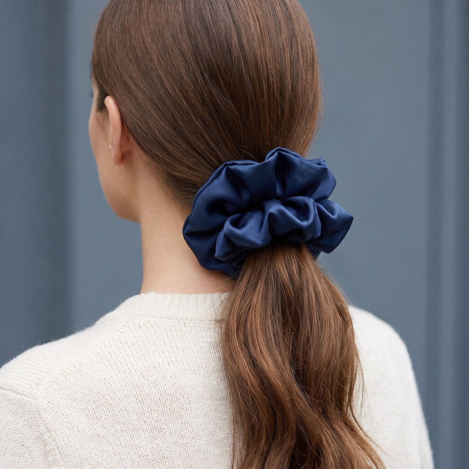 Low ponytail tied with the large navy KINT silk scrunchie