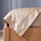 Satin bound border and mitred corner of the jacquard duvet cover
