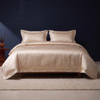 KINT silk and cotton jacquard four-piece bedding set in Champagne Petal on a bed in a calm bedroom