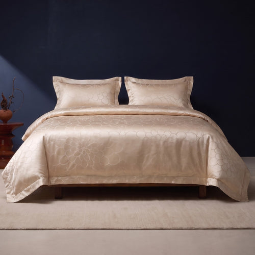 KINT silk and cotton jacquard four-piece bedding set in Champagne Petal on a bed in a calm bedroom