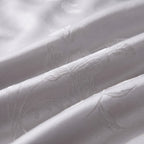 Close-up of the silver jacquard weave with its woven lily pattern