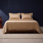 Bed made with the satin flat sheet and two pillowcases only