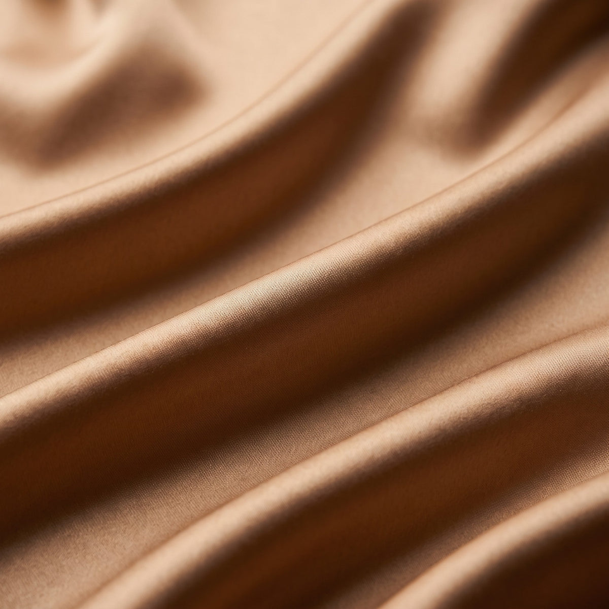 Close-up of light gold silk and cotton satin in soft folds