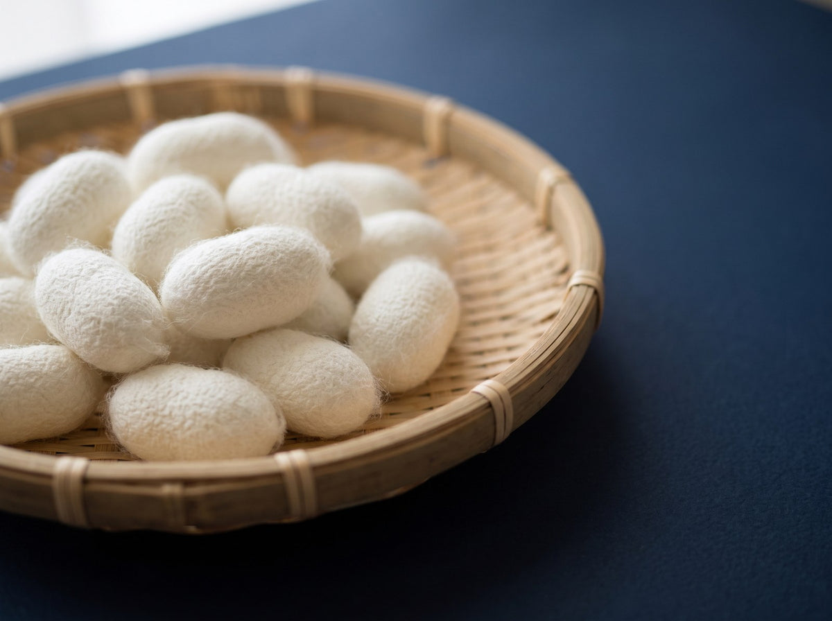 White mulberry silk cocoons in a bamboo tray