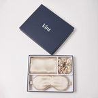 KINT 22 momme mulberry silk gift set (pillowcase, sleep mask and scrunchie) in Champagne, in a navy KINT gift box