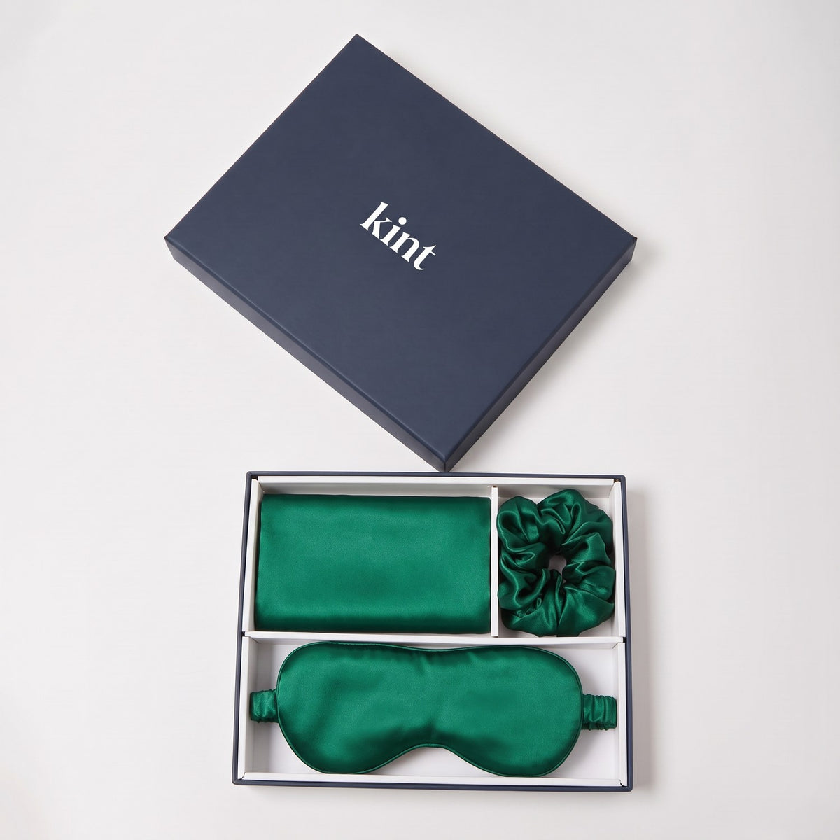 KINT 22 momme mulberry silk gift set (pillowcase, sleep mask and scrunchie) in Emerald, in a navy KINT gift box