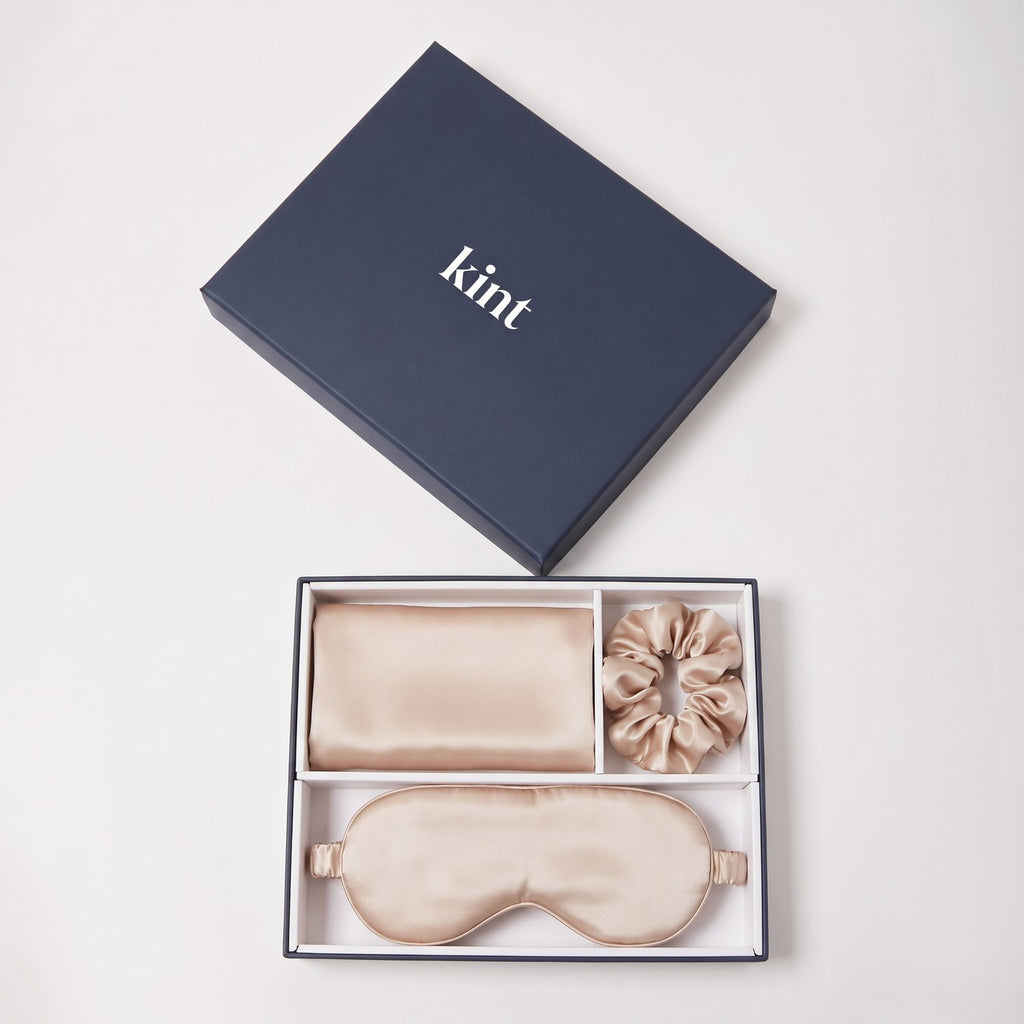 KINT 22 momme mulberry silk gift set (pillowcase, sleep mask and scrunchie) in Nude, in a navy KINT gift box