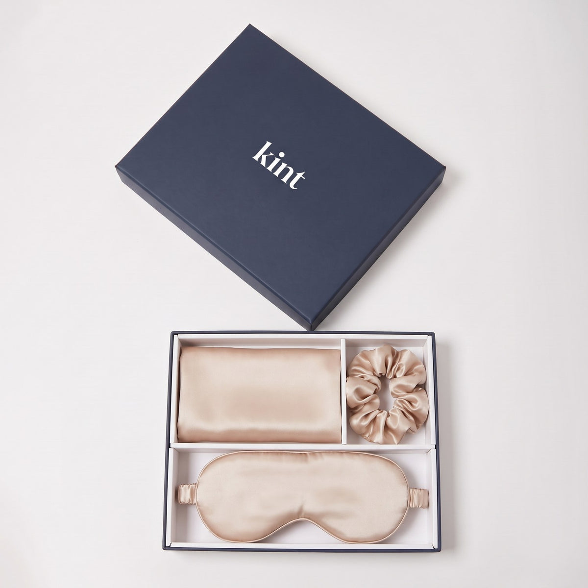 KINT 22 momme mulberry silk gift set (pillowcase, sleep mask and scrunchie) in Nude, in a navy KINT gift box