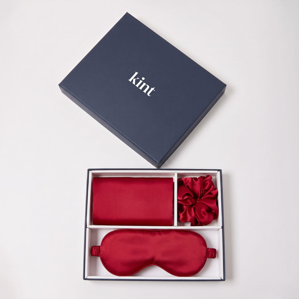 KINT 22 momme mulberry silk gift set (pillowcase, sleep mask and scrunchie) in Ruby Red, in a navy KINT gift box