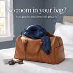 The KINT silk travel set packed in its pouch inside a leather weekend bag